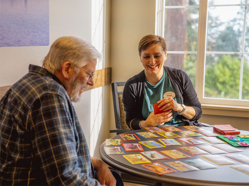 Nurse smiling while playing games with resident