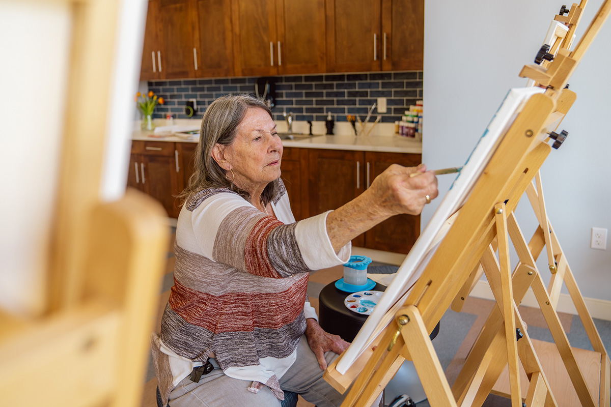 Senior woman painting a picture