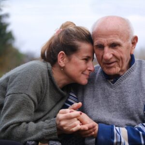 Woman Embraces her Elderly Father Outside