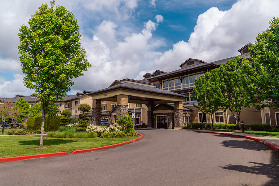 Exterior photo of driveway and main entrance to Fieldstone Village at Keizer Ridge in Keizer, Oregon, a premier assisted living and memory care community.