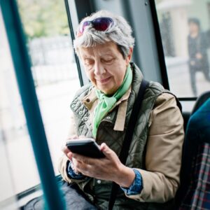 Older adult woman taking public transportation.