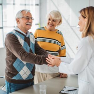 An older man and his wife at a doctor's appointment.