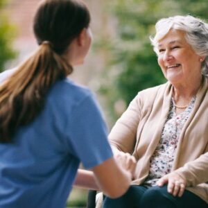A woman talks to an older woman as she prepares to move into senior living