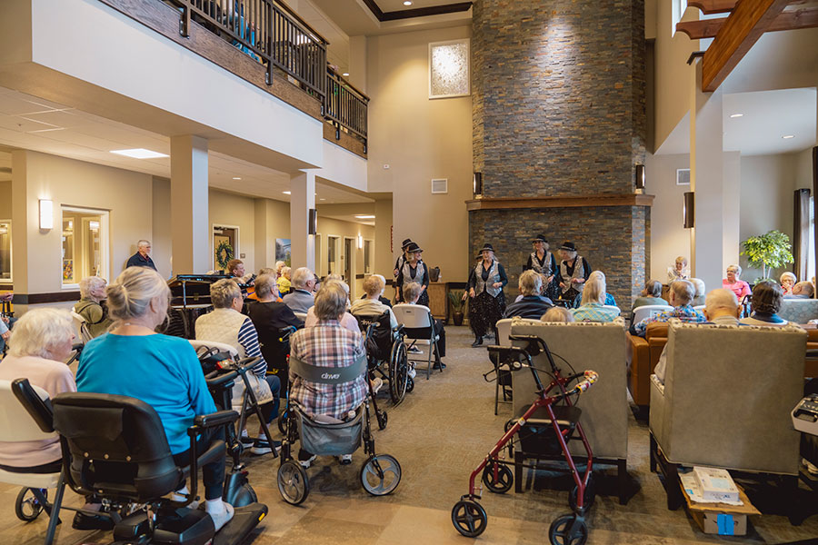 Residents enjoying a performance in a communal space.