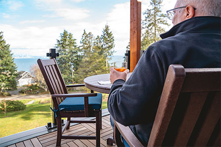 Older man sitting outside enjoying the view