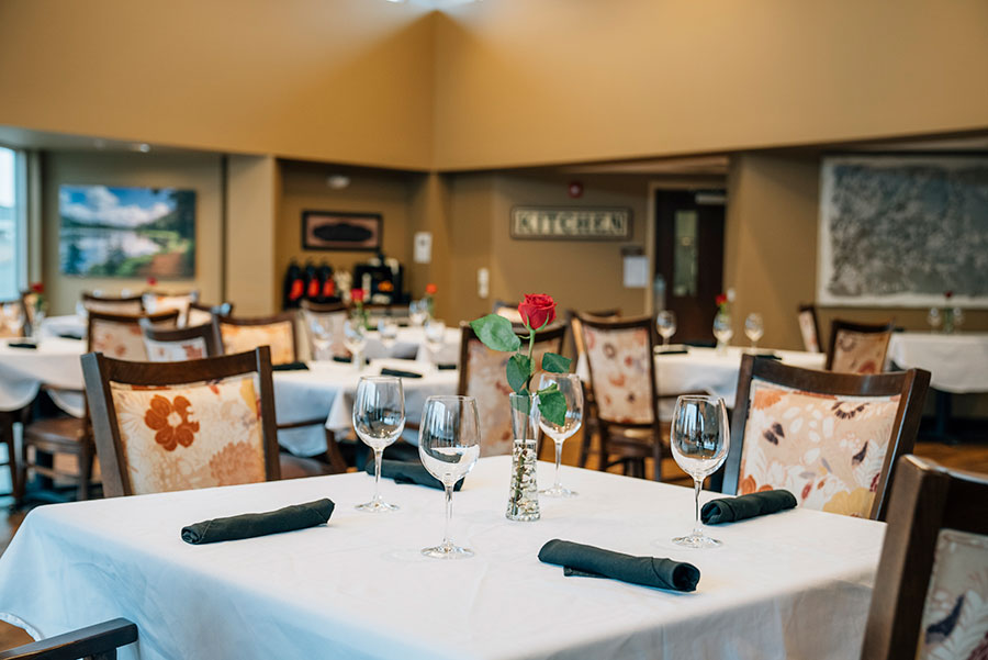 Elegant restaurant setting with neatly arranged tables and flowers.