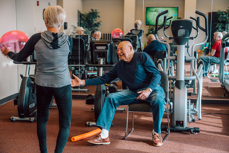 Seniors exercising and engaging in a fitness center.