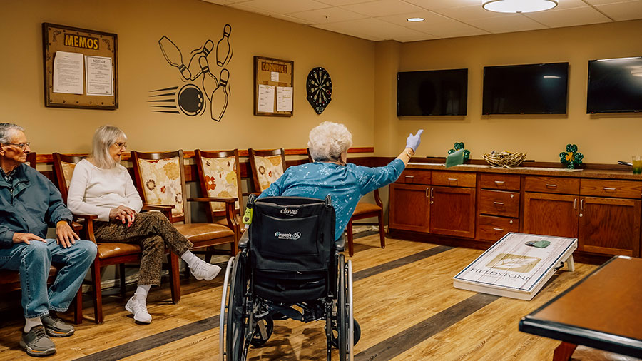 Seniors enjoying games in a communal activity room.