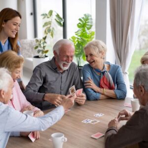 A group of friends play cards at a senior living community.